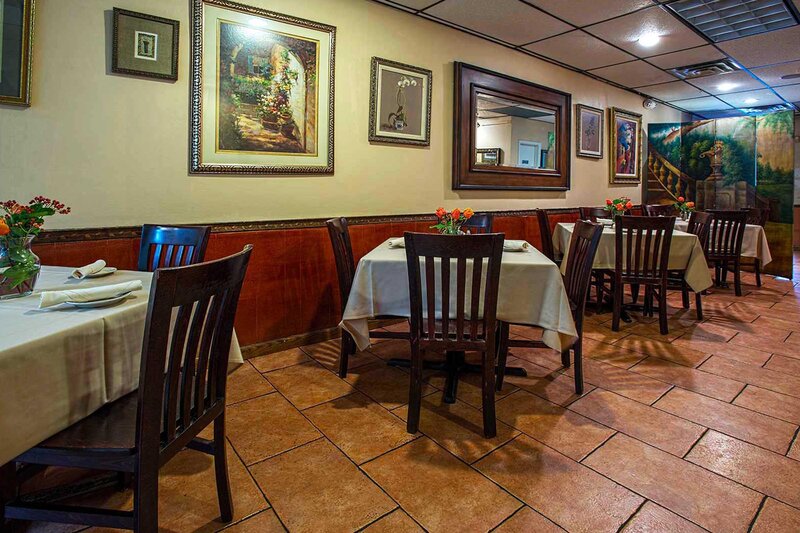 Dining room with view of four set tables